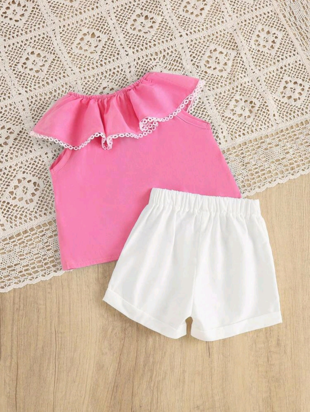 Pink flared blouse and white shorts