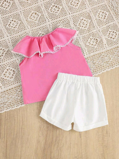 Pink flared blouse and white shorts